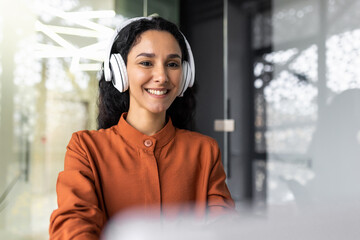 Close-up photo of young beautiful business woman with curly hair Hispanic woman.