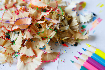 Closeup pencil and color pencil stack with shavings. Artistic education concept white background.