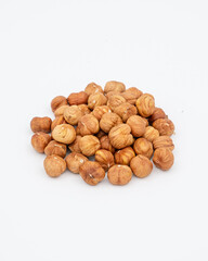 Peeled hazelnuts on a white background