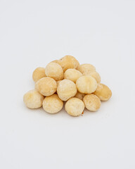 Macadamia hazelnuts peeled on a white background