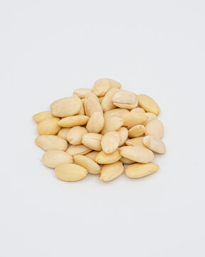Peeled almonds on a white background