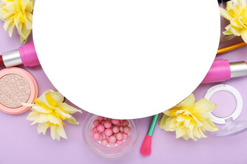 Blank card with frame made of different cosmetics and daffodils  on lilac background