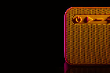 Modern wireless speaker on black background, closeup