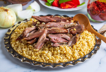 Turkish foods; lamb shank tandoori on bulgur wheat rice (Turkish name; bulgur bugday pilavi kuzu incik tandir, kuzu tandir)