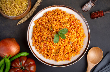 Traditional turkish bulgur pilaf with tomato sause in plate (Turkish name; meyhane pilavi)