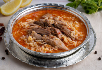 Turkish Soup Beyran with Lamb Meat, Rice, Chopped Garlic and Vinegar Sauce. Traditional Organic Food. Traditional soup of Gaziantep, Turkey. (Turkish name; Beyran corbasi)