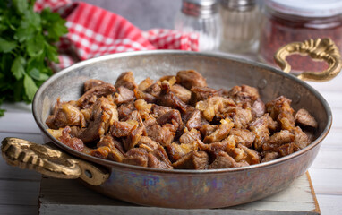 Muslims Traditional Sacrifice holiday food lamb, Turkish roasted meat in copper pot on table top. Turkish Kavurma. (Turkish name; Kurban kavurma)