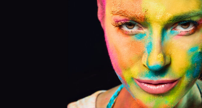 Mysterious sensual woman covered in rainbow colored powder. Colors Holi festival. Beauty spring concept