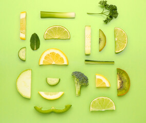 Composition with different fresh fruits and vegetables on green background