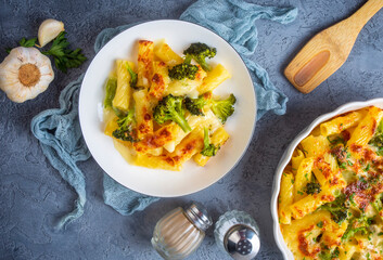 Pasta baked with broccoli and chicken. Broccoli, cheese and gratin sauce on baked penne pasta.