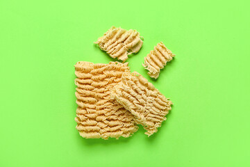 Raw instant noodles on light green background