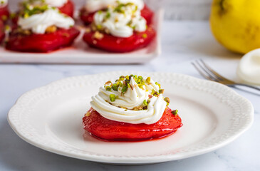 Traditional Turkish style quince dessert. The quince is cooked until soft, sherbet is poured on it, and served with cream and walnuts. It is one of the most popular Turkish desserts.(Ayva Tatlisi)