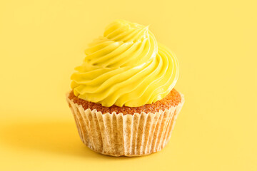 Tasty cupcake on yellow background