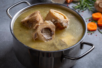 Boiled bone and broth. Homemade beef bone broth is cooked in a pot on. Bones contain collagen, which provides the body with amino acids, which are the building blocks of proteins.