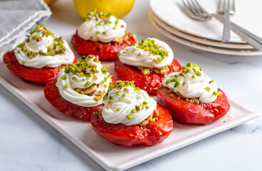 Traditional Turkish style quince dessert. The quince is cooked until soft, sherbet is poured on it, and served with cream and walnuts. It is one of the most popular Turkish desserts.(Ayva Tatlisi)
