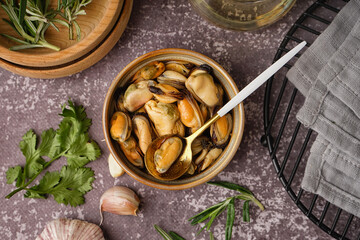 Bowl with pickled mussels on grey grunge table