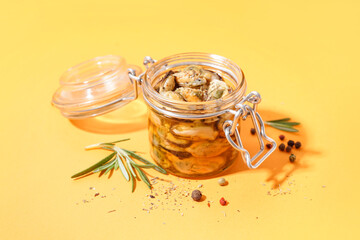 Jar with pickled mussels on orange background