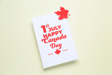 Card with text 1ST JULY HAPPY CANADA DAY and maple leaf on white background