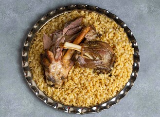Turkish foods; lamb shank tandoori on bulgur wheat rice (Turkish name; bulgur bugday pilavi kuzu...