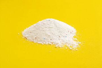 A pile of washing powder with blue and red granules.