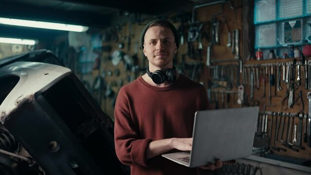 Mastering Success: Confident Professional in Brown Sweater and Green Hat Working on Laptop in Engaging Workspace Generative AI