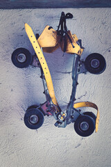 vintage yellow roller skates on a nail in a old wall	
