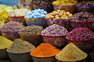 Variety of spices and dried herbs flowers on the arab street market stall. Dubai Spice Souk in Deira, United Arab Emirates.