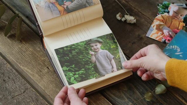 Photographic printing concept. Female hands leaf through photo album with printed photos Generative AI