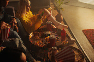 Friends socializing with takeout at home.