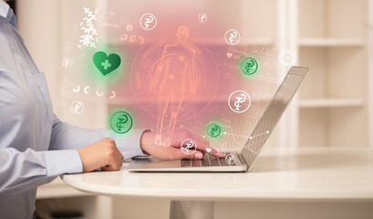 Doctor working on laptop with healthcare concept