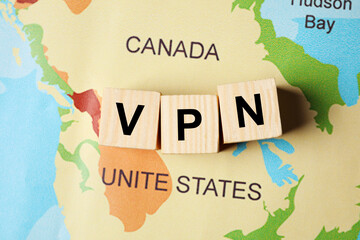 Acronym VPN (Virtual Private Network) made of wooden cubes on world map, flat lay