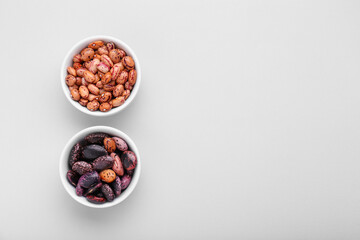 Different kinds of kidney beans on white background, top view. Space for text