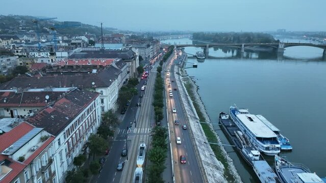Aerial view of Budapest Margaret Bridge or Margit hid over River Danube, embankment. Public transport in the city. Yellow tram passing through the bridge