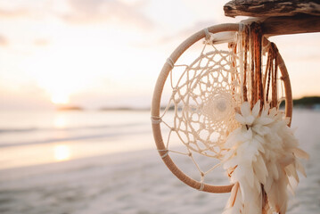 Boho dream catchers hanging on beach at sunset. Generative AI © Irina Bort