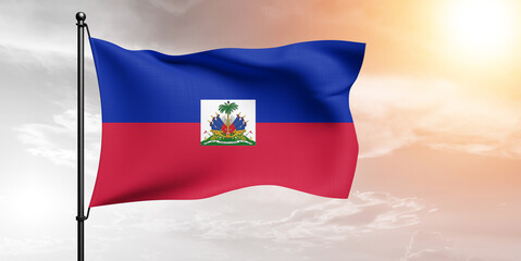 Haiti national flag cloth fabric waving on beautiful sky grey Background.