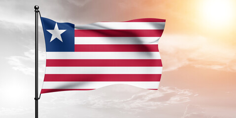 Liberia national flag cloth fabric waving on beautiful sky grey Background.