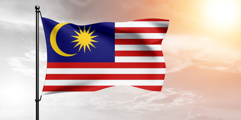 Malaysia national flag cloth fabric waving on beautiful sky grey Background.