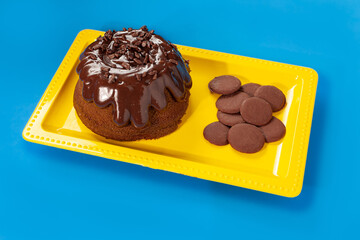 Volcano Chocolate cake with chocolate sprinkles by chocolate chips on yellow plate on grass pattern background - Vulcan cake