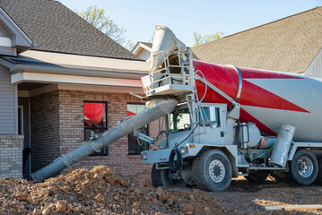 mixer truck is transporting and pouring cement at construction site
