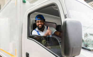 Happy African American delivery service man driver in uniform sitting smiling and thumb up with...