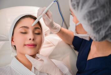 Professional specialist cosmetologist making mesotherapy with treatment facial skin care for fresh clean in beauty clinic.