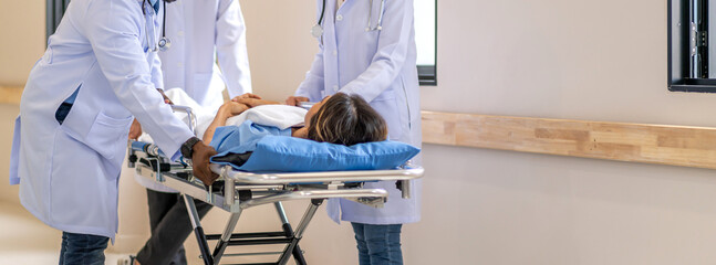 Group of professional medical doctor team and assistant with stethoscope in uniform taking seriously injured coma patient to operation emergency theatre room in hospital.health medical care concept © Art_Photo