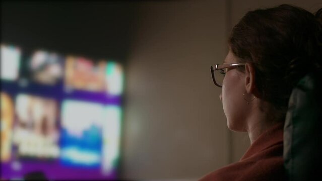 Close Up of Caucasian Woman's Face Browsing Television Guide. Shot with ARRI Alexa in ARRIRAW and exported QuickTime Apple ProRes 422 HQ.