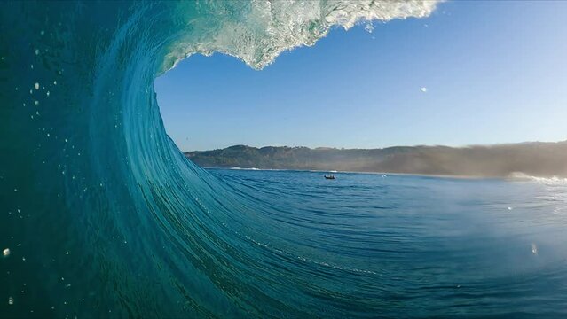 POV of Surfer in the Barrel, View from inside the tube of surfer riding perfect blue ocean wave