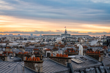 Fototapeta na wymiar Sunrise above Paris skyline, France. View from the roof of old town building