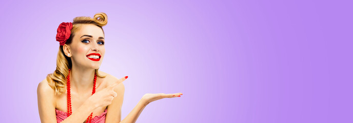 Wide photo of happy excited smile woman hold, give, promote, pointing ad. Blond girl in pin up...