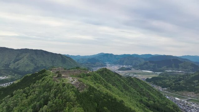 Aerial pullback of view on ancient Takeda Castle ruins in mountains of Hyogo, Japan Generative AI