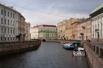 Fototapeta na wymiar Moika River Embankment and the 2nd Winter Bridge on a cloudy spring morning, Saint Petersburg, Russia