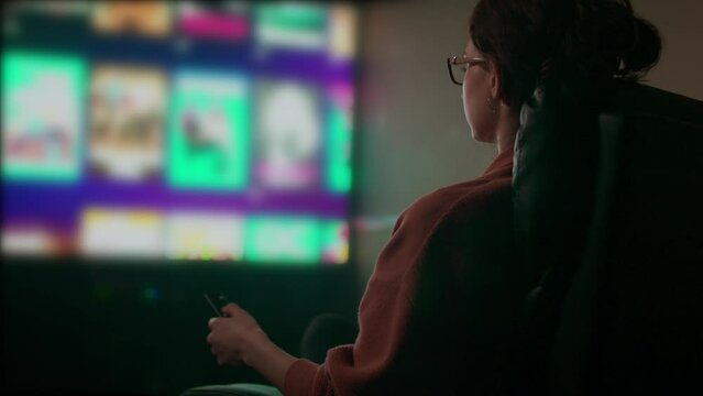Caucasian Woman Browsing Television Guide. Shot with ARRI Alexa in ARRIRAW and exported QuickTime Apple ProRes 422 HQ.