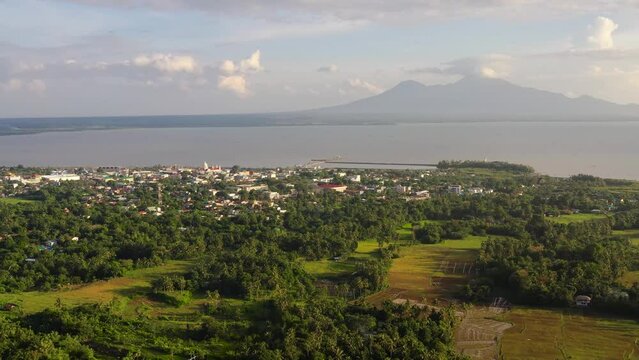 Sorsogon City, Luzon, Philippines. Town by the sea, top view. Landscape in Asia. Summer and travel vacation concept. View of a small town and a volcano in the distance. Generative AI